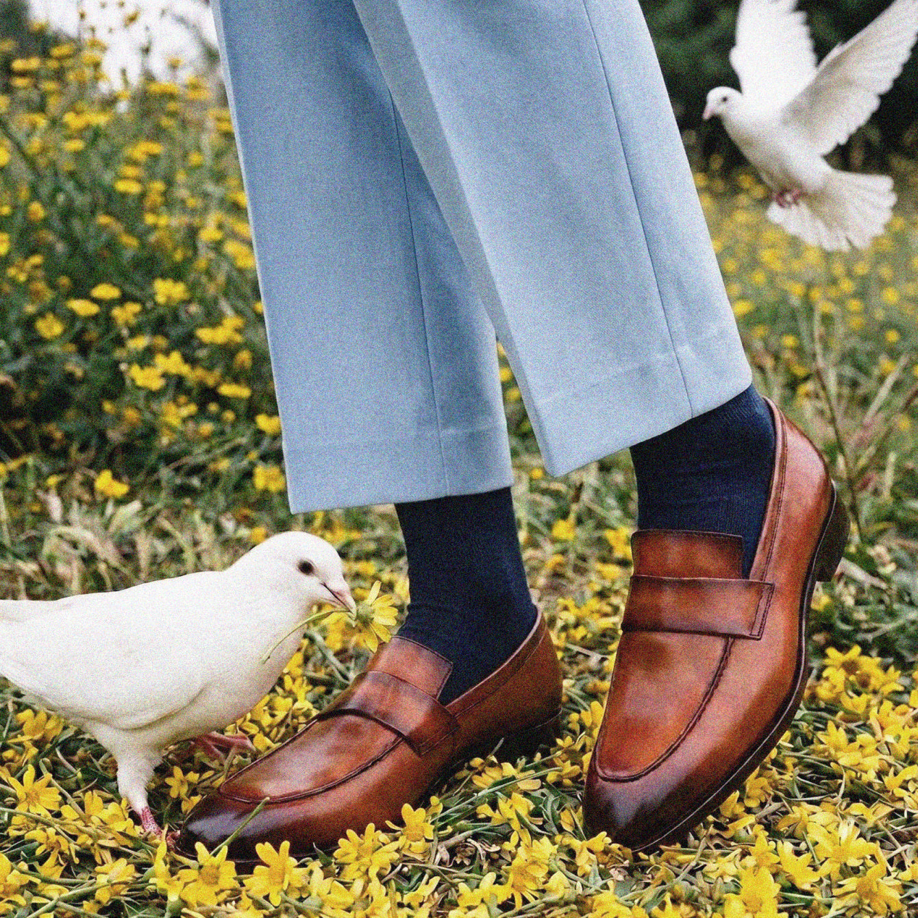 Man standing wearing men's brown Italian leather loafer dress shoes