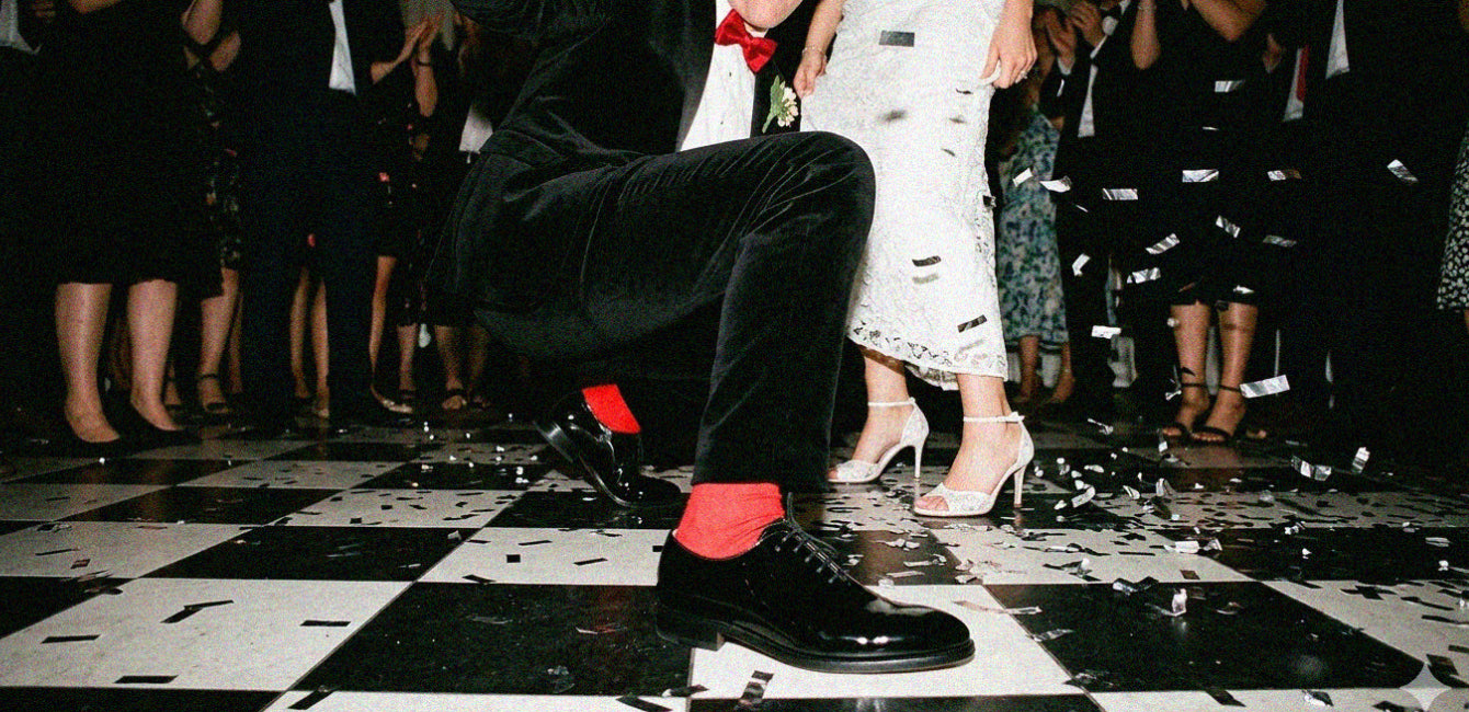 Man dancing at wedding wearing men's black patent Italian leather wholecut dress shoes with laces