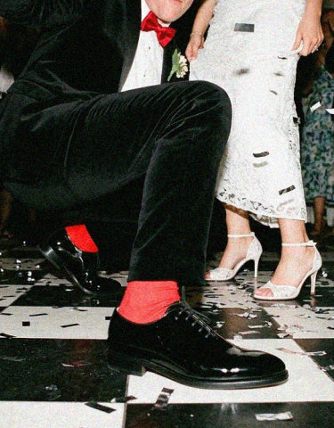 Man dancing at wedding wearing men's black patent Italian leather wholecut dress shoes with laces