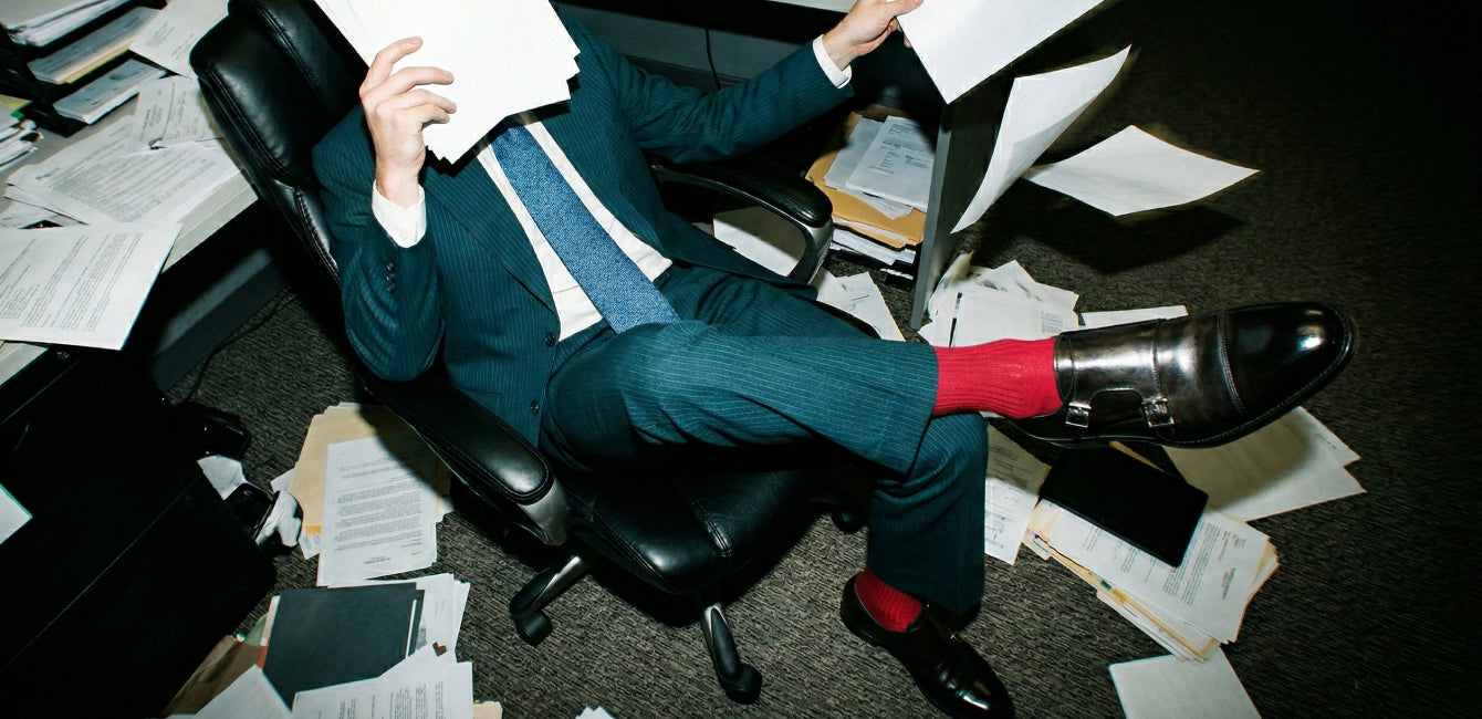 Man in a suit sitting in office wearing men's black Italian leather monkstrap dress shoes