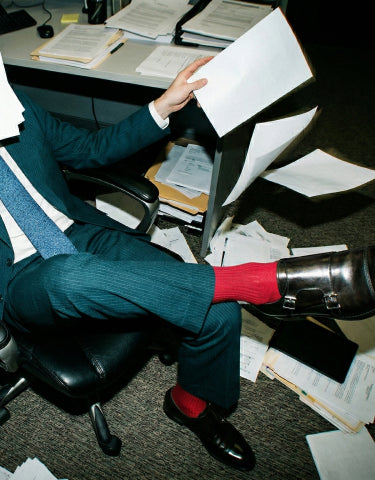Man in a suit sitting in office wearing men's black Italian leather monkstrap dress shoes